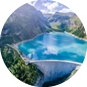 Water dam and reservoir lake in Swiss Alps mountains producing sustainable hydropower, hydroelectricity generation, renewable energy to limit global warming, aerial view, decarbonize, summer